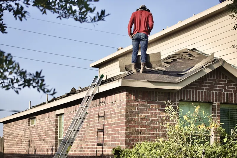 Professional roofer working on a residential roof in Victory Park